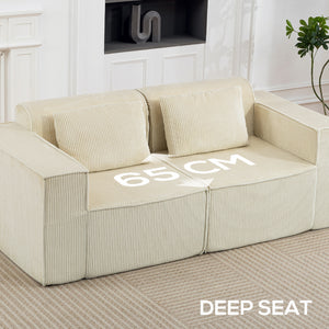 Three-seater corduroy sofa with deep seat, wide armrests, and two cushions, beige.