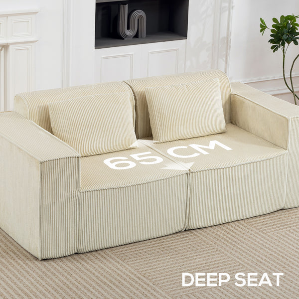 Three-seater corduroy sofa with deep seat, wide armrests, and two cushions, beige.