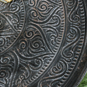 Vintage round coffee table with hammered top and metal frame, pewter color