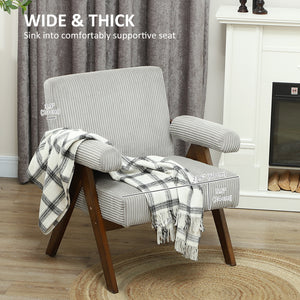 Corduroy accent chair with wide seat and padded armrests, light grey