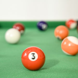 Mini foldable pool table with balls, cues, chalk and brush.