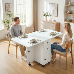 Dining table with drop leaves on castors with drawers and cupboard, marbled white
