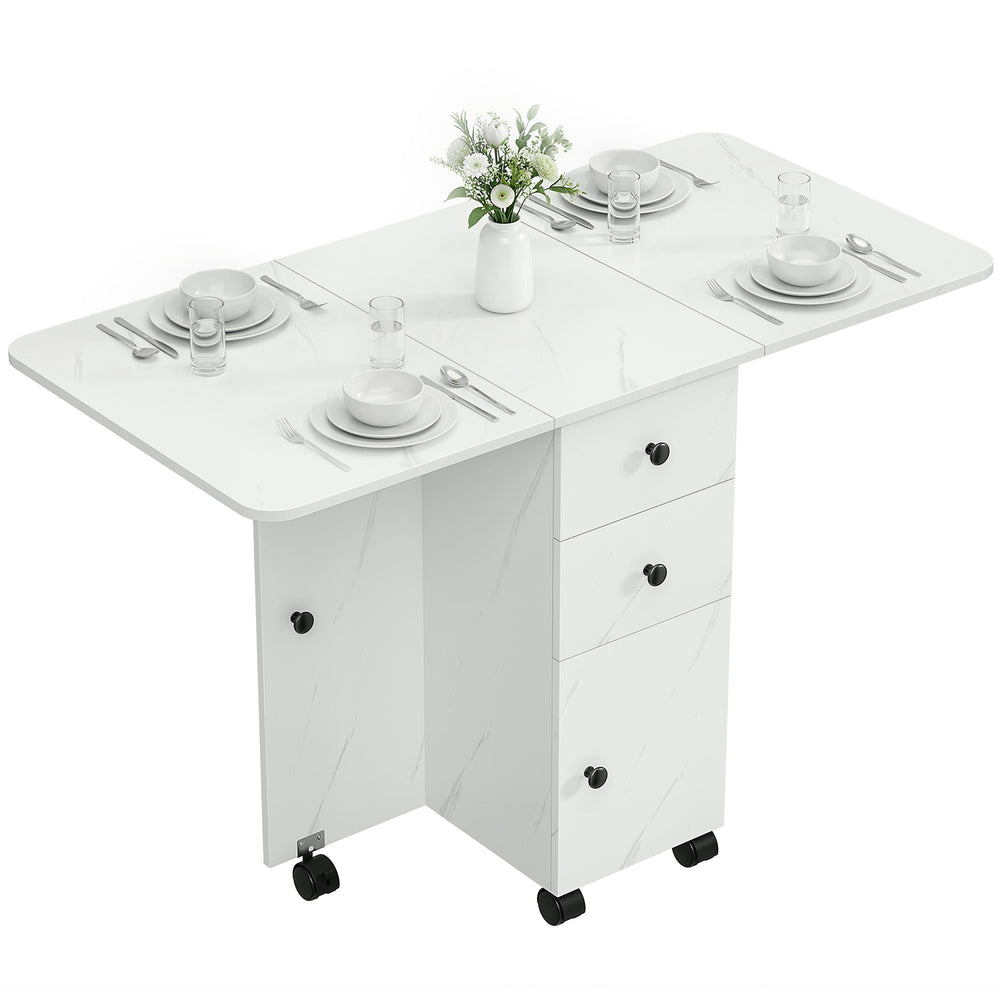 Dining table with drop leaves on castors with drawers and cupboard, marbled white