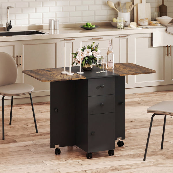 Drop-leaf dining table on casters with drawers and cupboard, rustic brown and black.