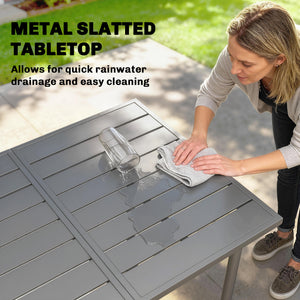 Outdoor dining table for 6 people, made of metal with a slatted top.
