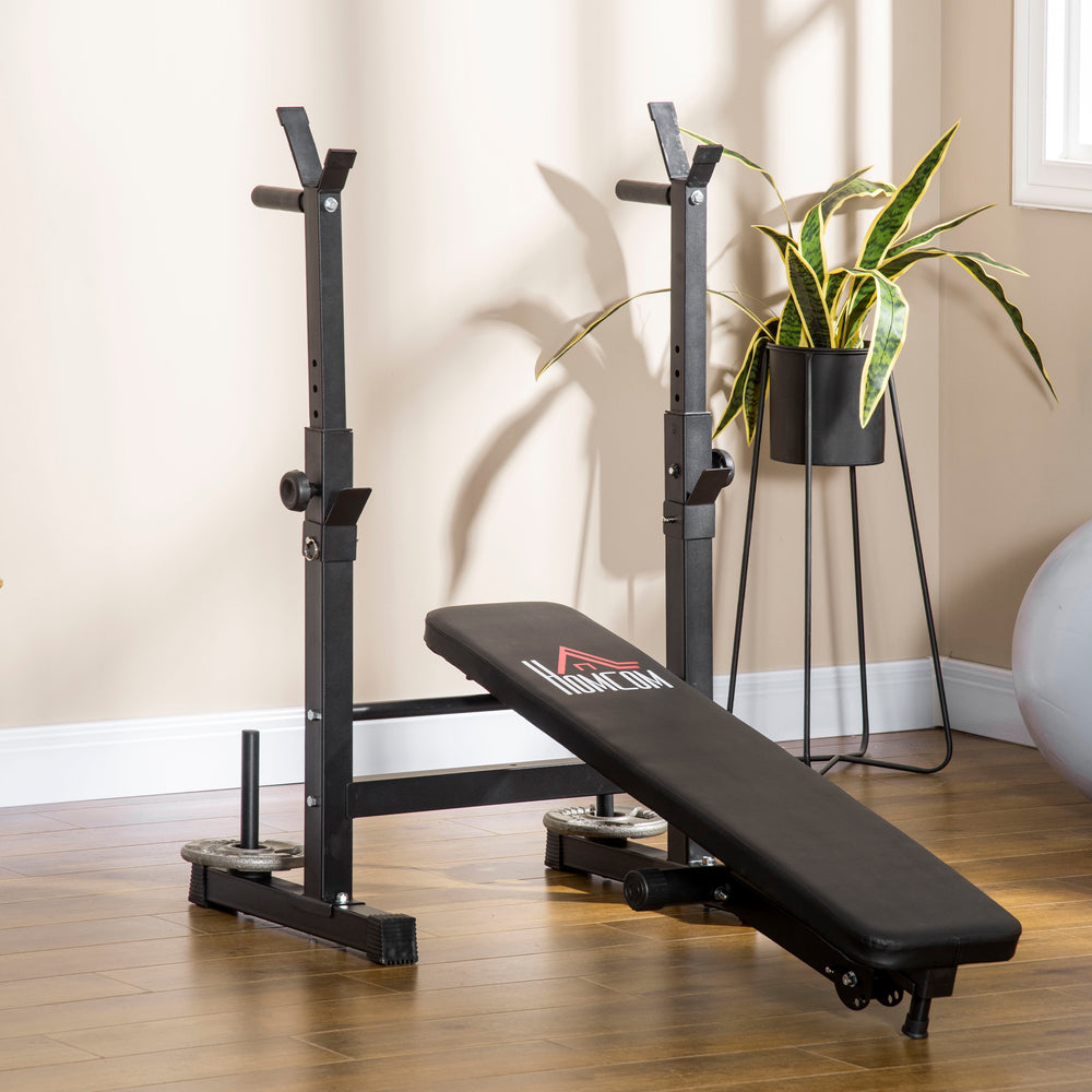 Adjustable, foldable weight bench with dumbbell rack and dip station, black.