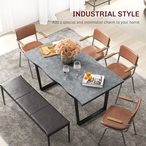 Industrial dining table with wavy edge top and steel legs, seats up to 6, cement gray