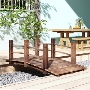 Wooden garden bridge with decorative side railings, stained wood