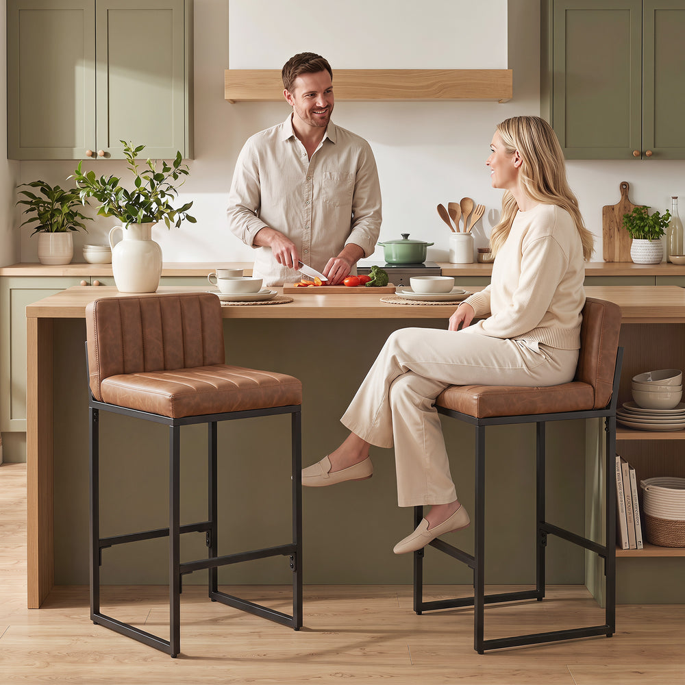 Set of 2 faux leather bar stools with curved backrest and footrest, brown
