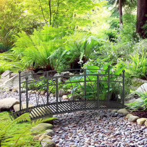 Metal garden walkway with railing and decorative scrolls, black