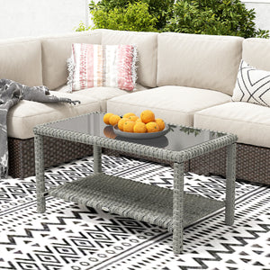 Outdoor coffee table in woven resin with glass top and storage shelf, grey
