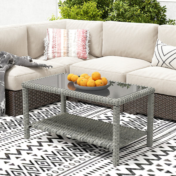 Outdoor coffee table in woven resin with glass top and storage shelf, grey