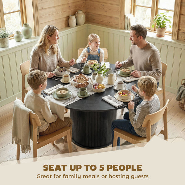 Round black dining table for 5 with fluted central pedestal.