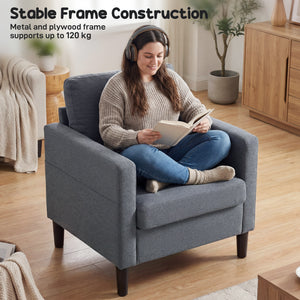 Modern upholstered armchair with thick, padded seat and armrests, dark grey 