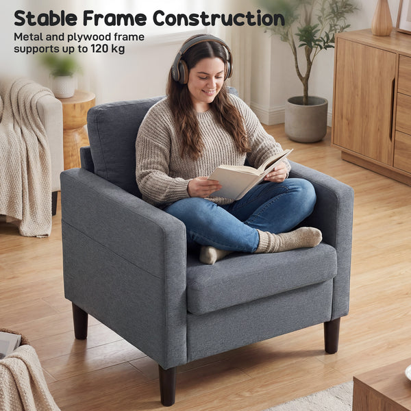 Modern upholstered armchair with thick, padded seat and armrests, dark grey 