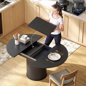 Extendable kitchen table for 6 to 8 people, farmhouse style, with a pedestal base and black wood finish.