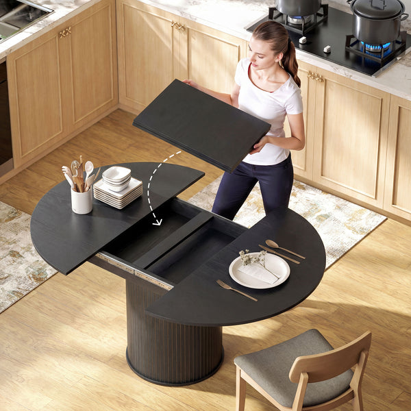 Extendable kitchen table for 6 to 8 people, farmhouse style, with a pedestal base and black wood finish.