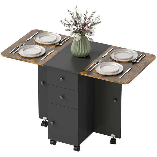 Drop-leaf dining table on casters with drawers and cupboard, rustic brown and black.