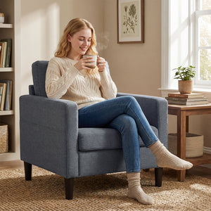 Modern upholstered armchair with thick, padded seat and armrests, dark grey 