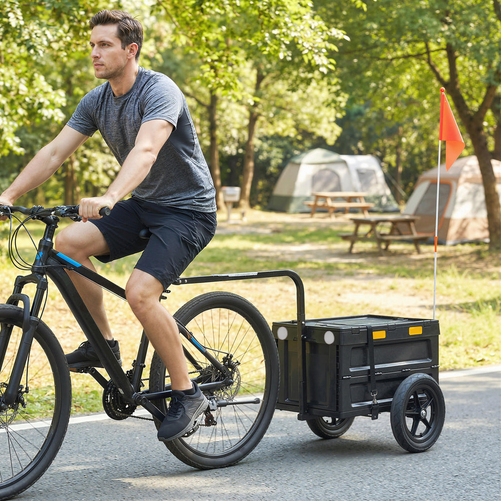 Bicycle trailer with foldable storage box and lid, quick-release wheels, reflective stickers, and safety flag