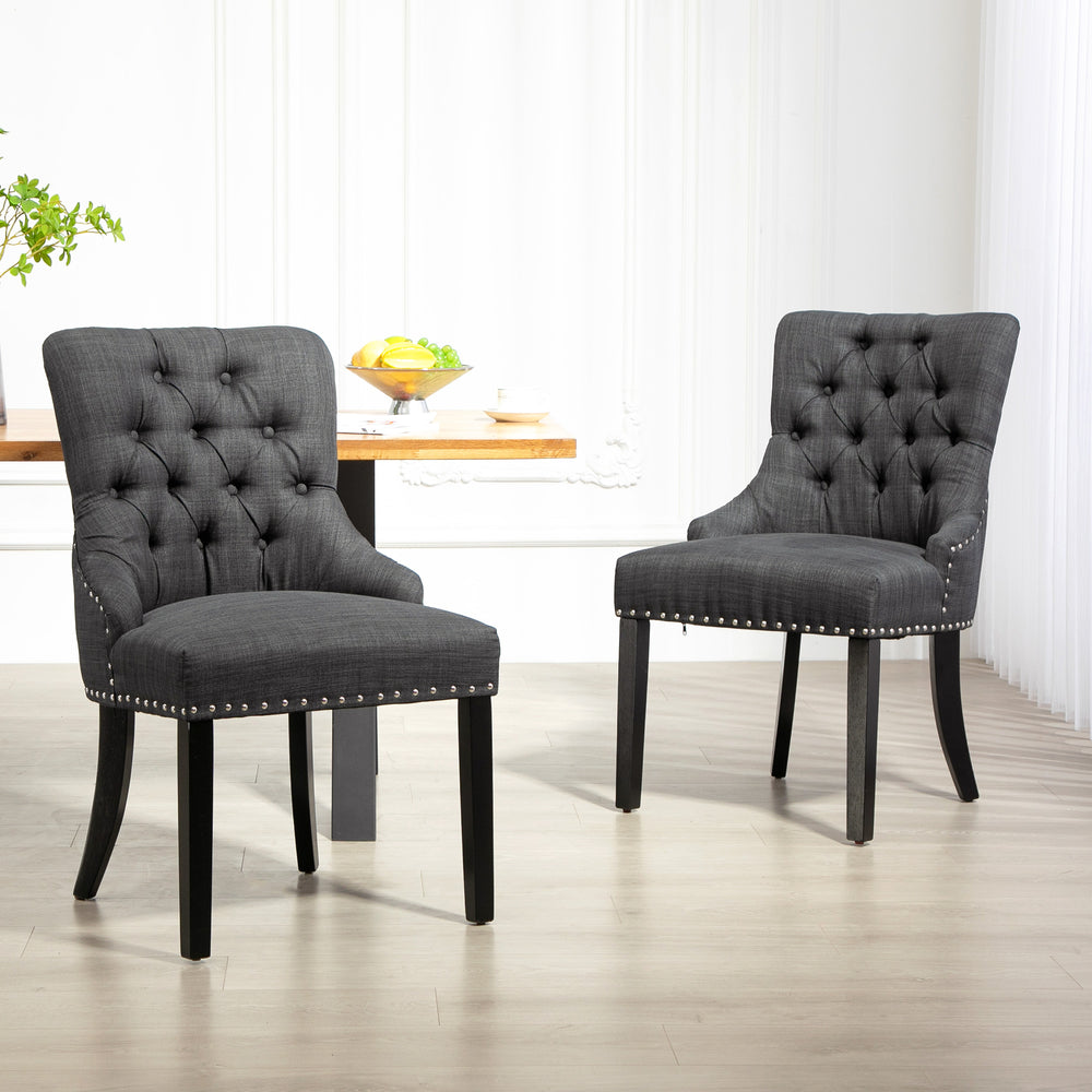 Set of 2 linen dining chairs with studded trim and wooden legs, dark grey