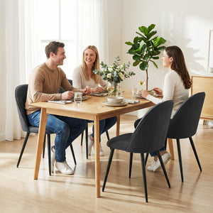 Set of 4 modern dining chairs with metal legs, shell back, and upholstered seat, black.