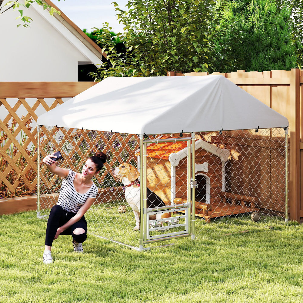 Outdoor dog kennel with adjustable and rotating bowls
