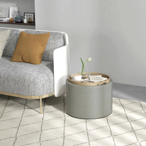 Round coffee table with hidden storage and gray linen upholstered top