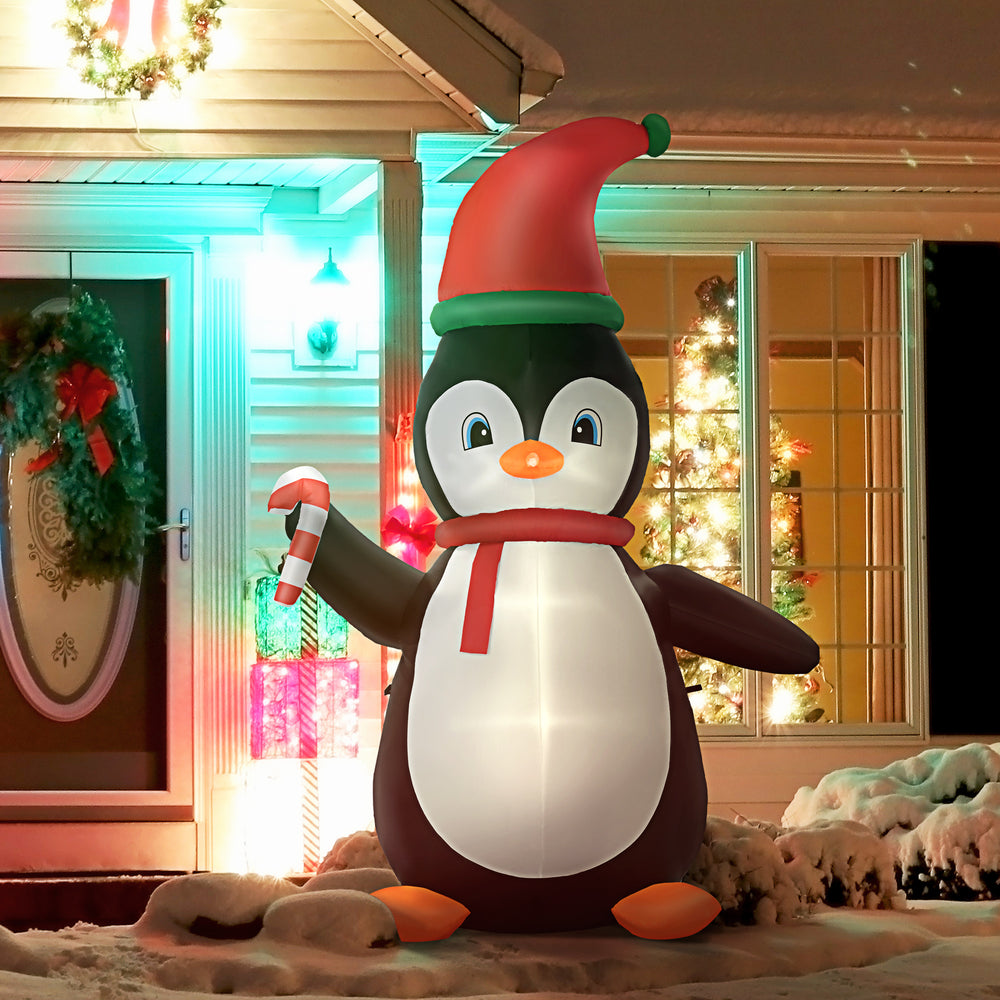 Inflatable penguin holding a 2.4 meter candy cane
