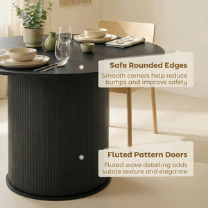 Round black dining table for 5 with fluted central pedestal.
