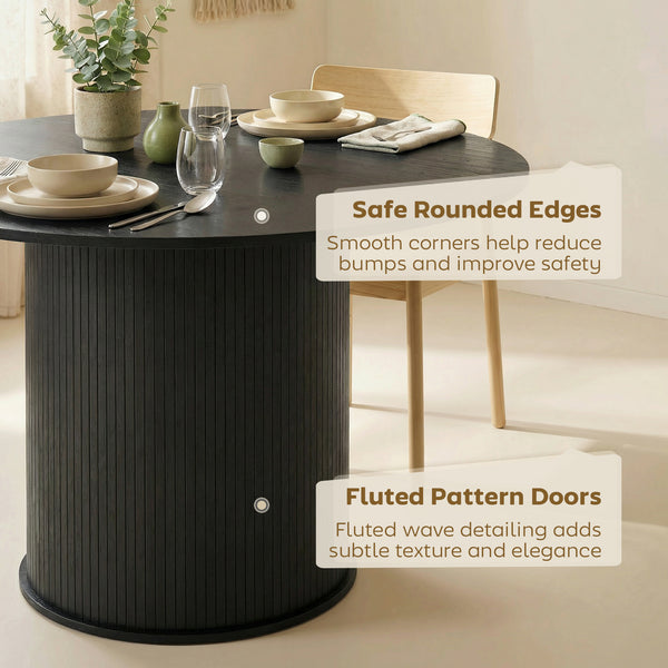 Round black dining table for 5 with fluted central pedestal.