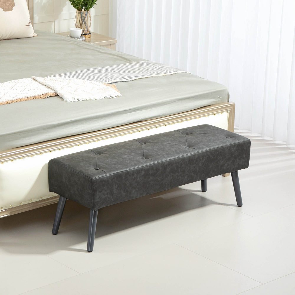 Bedroom bench with button tufting upholstered in faux leather, gray