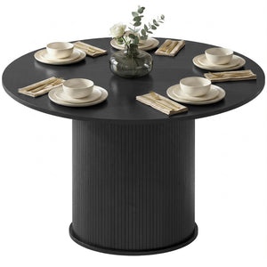 Round black dining table for 5 with fluted central pedestal.