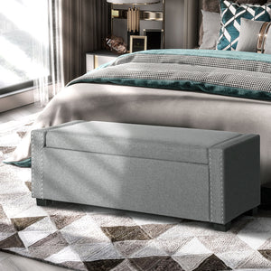 Folding storage bench upholstered in fabric, light gray