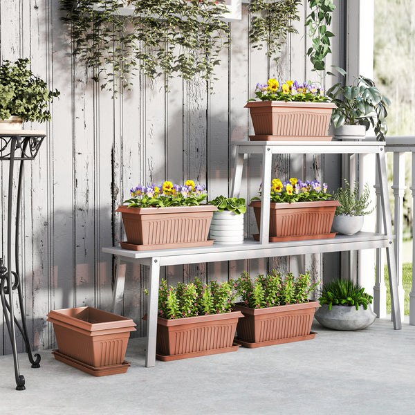 Set of 7 plastic flower pots with drainage holes and saucers, brown