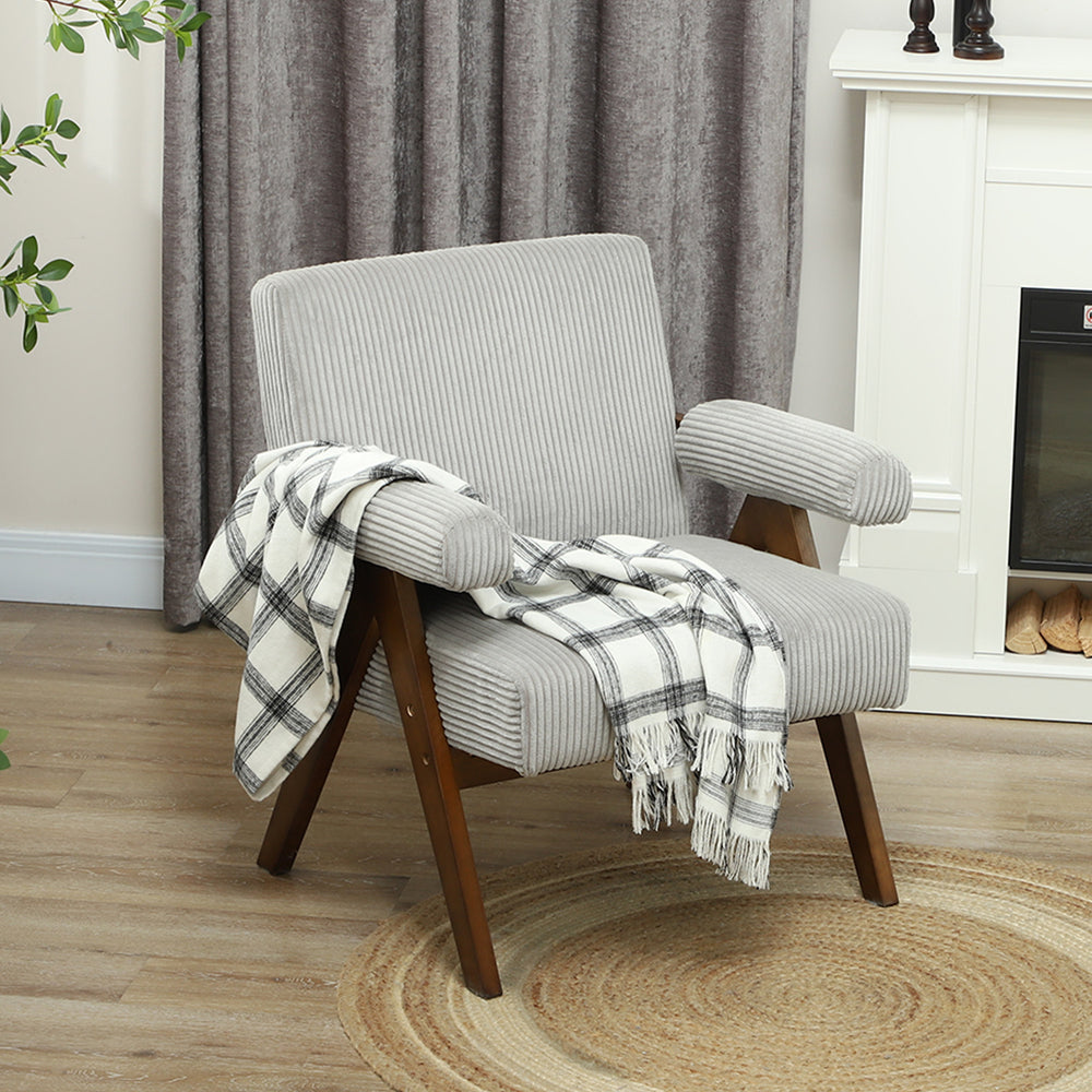 Corduroy accent chair with wide seat and padded armrests, light grey