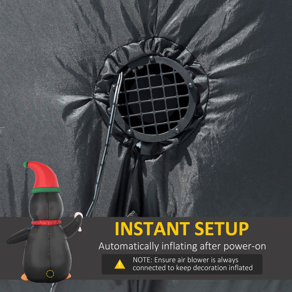 Inflatable penguin holding a 2.4 meter candy cane