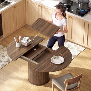 Extendable kitchen table for 6 to 8 people, farmhouse style, with a central pedestal and a walnut finish.