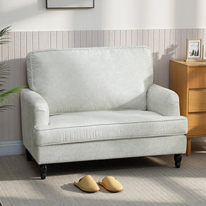 Modern faux leather accent chair with turned legs and wide seat, cream white
