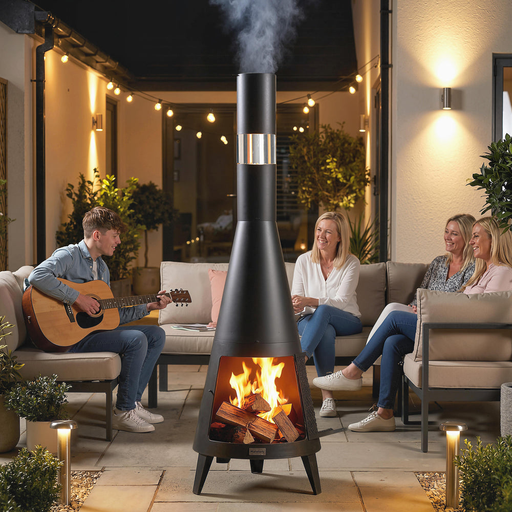 Outdoor wood-burning fire pit with chimney, poker, and spark screen, black