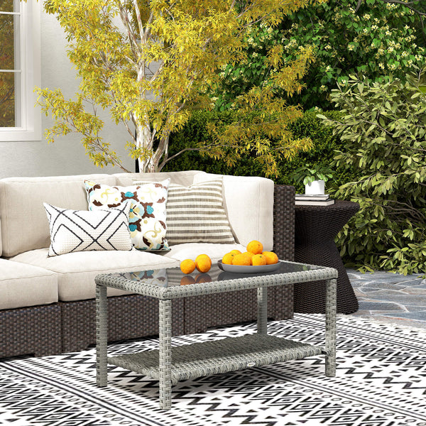 Outdoor coffee table in woven resin with glass top and storage shelf, grey