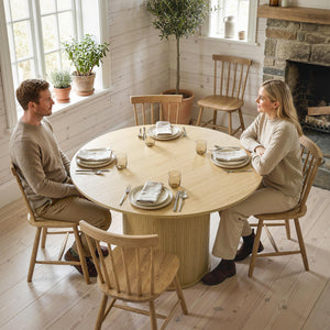 Round dining table for 5 people with a fluted central pedestal base, natural color.